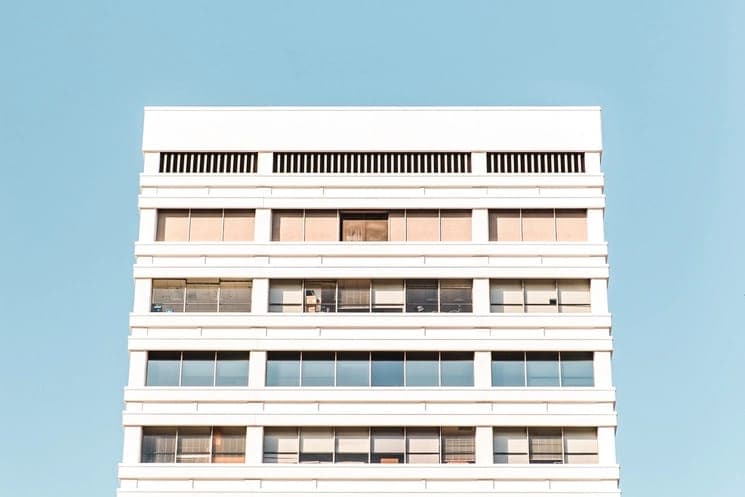 Multi-story apartment building against a blue sky